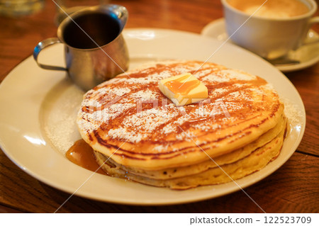 Chewy pancakes with butter and maple syrup 122523709