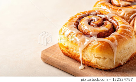 Fresh cinnamon rolls with vanilla glaze dripping down, perfect for breakfast Fresh cinnamon rolls with vanilla glaze dripping down, perfect for breakfast 122524797