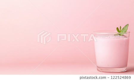 Creamy pink chia pudding in glass cup with mint garnish on pastel background 122524869