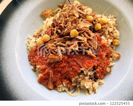 Egyptian cuisine Koshari, a local dish with plenty of fried onions and tomato sauce 122525455