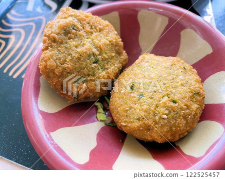 Egyptian dish taameya, deep fried broad bean and herb croquettes in sesame batter 122525457
