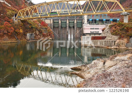 Tadami Line running over the sixth Tadami River Bridge with autumn leaves 122526198