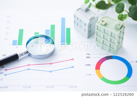 Business graph and corporate building with magnifying glass Business graph and corporate building with magnifying glass 122526260