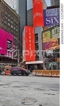 Modern look of a big metropolitan city with illuminated skyscrapers and classic architecture under a clear blue sky. Urban hustle and warm lighting create a vibrant and captivating cityscape 122526487