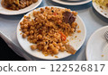 Delicious Rice Pilaf with Chickpeas, Carrots, Raisins and Meat Served on White Ceramic Plate 122526817