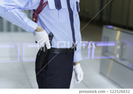 Close-up of a male security guard's hand holding a baton. Filming courtesy of Sky Perfect Tokyo Media Center. 122526832
