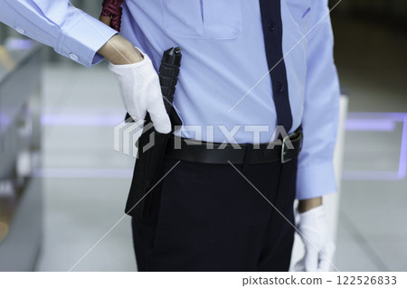 Close-up of a male security guard's hand holding a baton. Filming courtesy of Sky Perfect Tokyo Media Center. 122526833