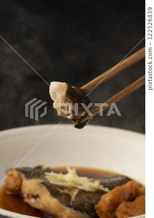 Picking up boiled flounder roe with chopsticks Picking up boiled flounder roe with chopsticks 122526839