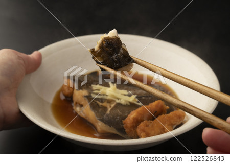 Picking up boiled flounder roe with chopsticks Picking up boiled flounder roe with chopsticks 122526843