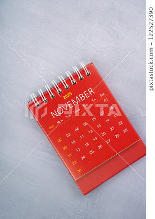 November 2025 red calendar on wooden blue background. November 2025 red calendar on wooden blue background. 122527390