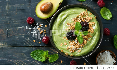 Delicious avocado smoothie bowl with granola, berries, and mint. 122529678