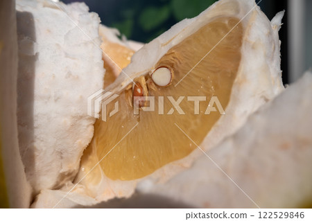 A close-up of fresh Banpeiyu flesh and seeds 122529846