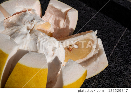 Close-up of the flesh and thick skin of a cut Banpeiyu Close-up of the flesh and thick skin of a cut Banpeiyu 122529847