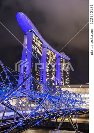 Night view of The Helix Bridge and the Marina Bay Sands Resort, Singapore, it's a pedestrian bridge linking the Marina Centre with Marina South. Night view of The Helix Bridge and the Marina Bay Sands Resort, Singapore, it's a pedestrian bridge linking the Marina Centre with Marina South. 122530181