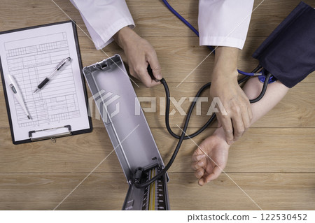 Doctor measuring a patient's blood pressure Medical image 122530452
