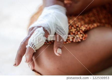 Hand of woman injured and bandaged Hand of woman injured and bandaged 122530953
