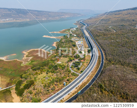 Drone shot aerial view landscape of the M6  motorway Expressway Nakhon Ratchasima Province - Bang Pa-in. Lam Ta Khong River and Mountain. Drone shot of scenic landscape rural place traffic. Nakhon 122530959