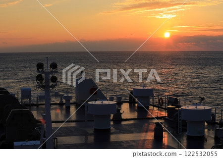 Watching the sunrise from the deck of a ship on the Pacific Ocean Watching the sunrise from the deck of a ship on the Pacific Ocean 122532055