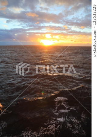 Sunrise time when the morning sun shines on the waves alongside the ship Sunrise time when the morning sun shines on the waves alongside the ship 122532229