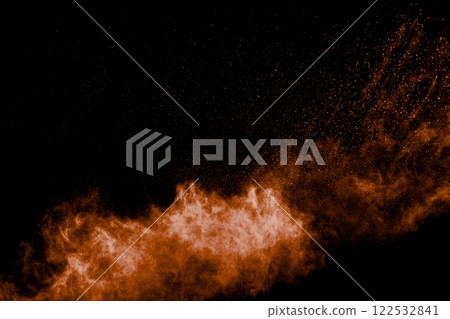 Orange cloud of smoke is floating in the air. The smoke is made up of tiny particles that are suspended in the air. 122532841