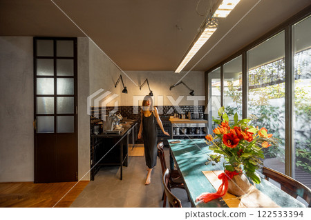 Woman Walking in a Modern Cozy Kitchen 122533394
