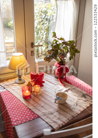 Cozy Rustic Table with Candles and Greenery 122533429