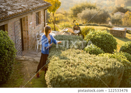 Woman in Rustic Garden 122533476