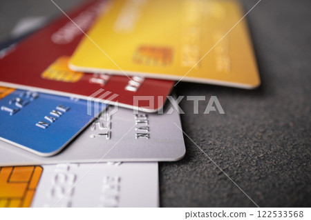 Pile of credit cards on dark grey background. Cashless technology and credit card payment concept. 122533568