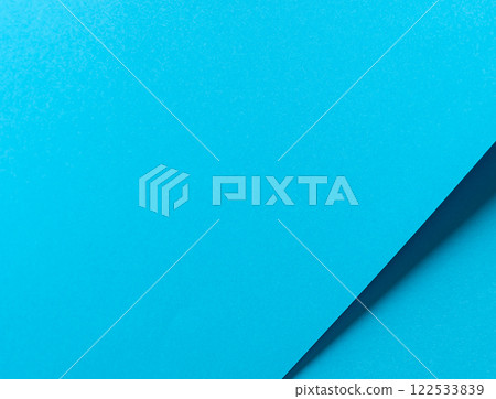 Blue paper background with a smooth matte finish and layered geometric accents. Bright pastel tones 122533839