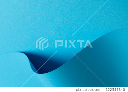 Blue paper background with a smooth matte finish and layered geometric accents. Soft shadows and a Blue paper background with a smooth matte finish and layered geometric accents. Soft shadows and a 122533840