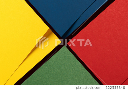 Bold geometric paper background divided into vibrant quadrants of yellow, blue, red, and green. Bold geometric paper background divided into vibrant quadrants of yellow, blue, red, and green. 122533848