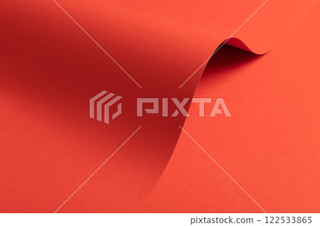 Fiesta red and orange paper background with a matte finish and smooth, curved folds. Vibrant, bold Fiesta red and orange paper background with a matte finish and smooth, curved folds. Vibrant, bold 122533865