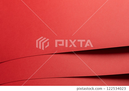 Red paper background with a matte texture and soft tones. Bold crimson and maroon hues create a 122534023