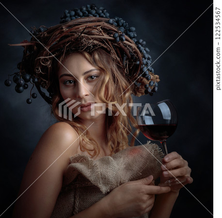 Beautiful blonde with long, wavy hair holding a glass of red wine. 122534567