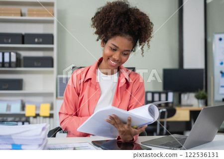Businesswomen hand working with tablet and laptop computer with documents on office desk in modern office. 122536131