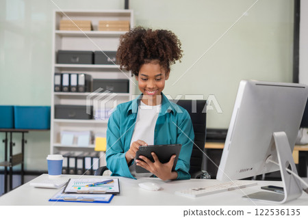 Business woman using tablet payments online shopping, omni channel, digital docking keyboard computer. 122536135