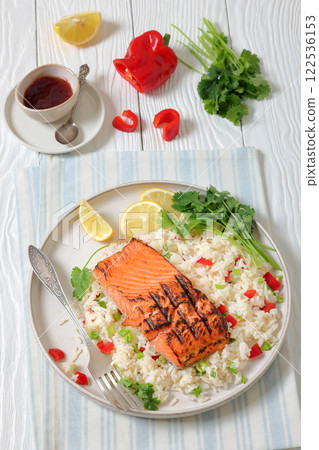 grilled red salmon fillet with rice, top view 122536153