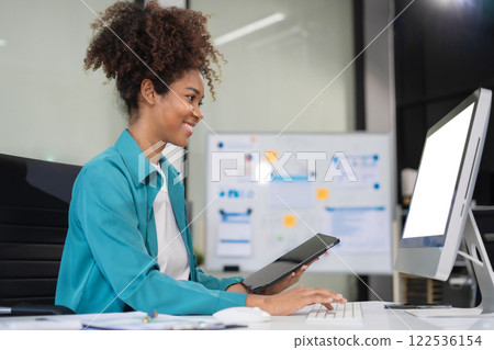 Business woman using tablet payments online shopping, omni channel, digital docking keyboard computer. 122536154
