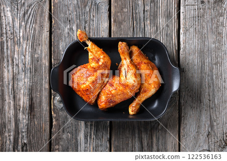 baked in oven three chicken leg quarters, top view 122536163