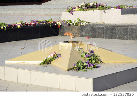 lilac flowers near the eternal flame at the Glory Memorial 122537020