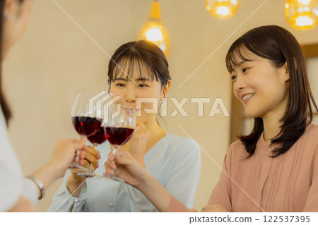 Woman holding a glass of alcohol Woman holding a glass of alcohol 122537395
