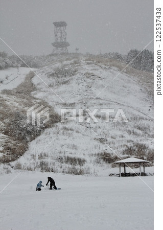 Children playing in a snowy field 122537438