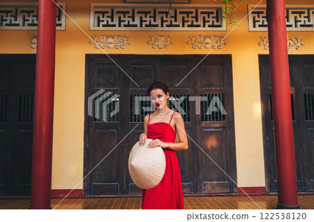 portrait of beautiful young woman tourist in Non La hat at Long Son Pagoda in Nha Trang in Vietnam 122538120