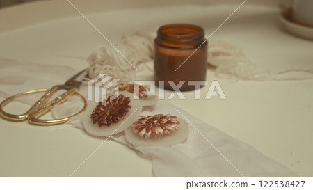 Handmade soy wax scented candle embedded with a flower for a springtime theme craft, creative eco-friendly sustainable zero waste lifestyle 122538427