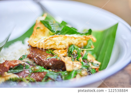 Thai style holy Basil beef stir fry with fried egg. 122538884