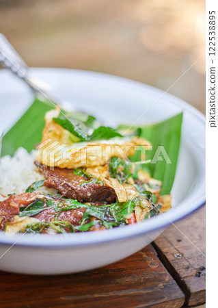 Thai style holy Basil beef stir fry with fried egg. 122538895