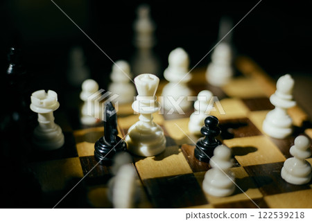 White and black chess pieces on chess board 122539218