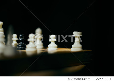 White and black chess pieces on chess board White and black chess pieces on chess board 122539225
