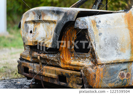 Close-up of the trunk of a burnt-out car. Close-up of the trunk of a burnt-out car. 122539504