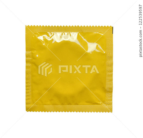 A vibrant yellow, sealed foil condom wrapper isolated on a clean white background, ideal for health, safe sex, and lifestyle-related stock photography. 122539597